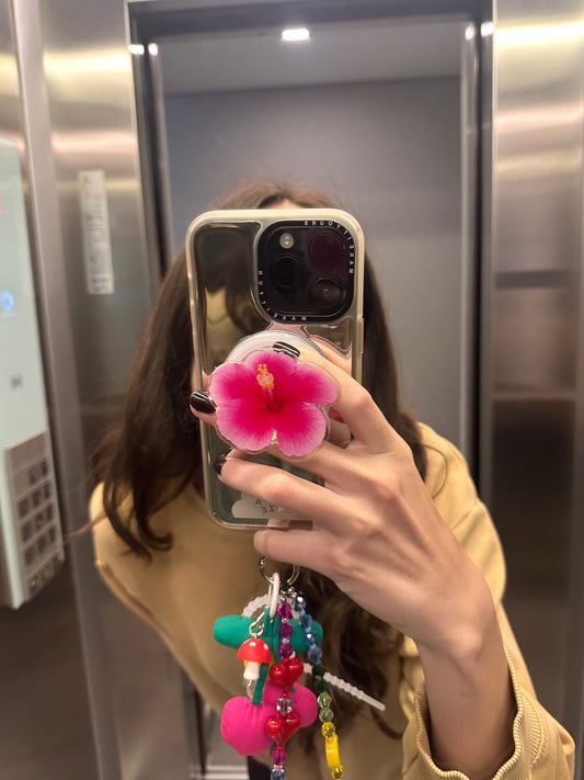 Pop Grippy para celular color rosa vibrante, diseño de hibisco, accesorio de agarre seguro para teléfono móvil.