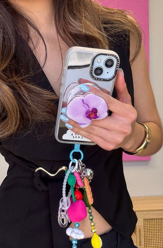 Sujetador de teléfono Pop Grippy con diseño de orquídea, accesorio para celular, agarre seguro para móvil, soporte expandible para smartphone.