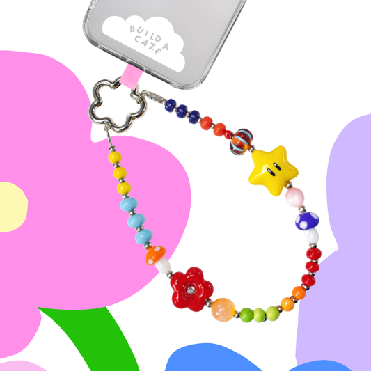 Mezcla multicolor de cuentas con formas de estrellas, hongos y flores Strappy vista frontal sobre un fondo blanco - Build A Caze